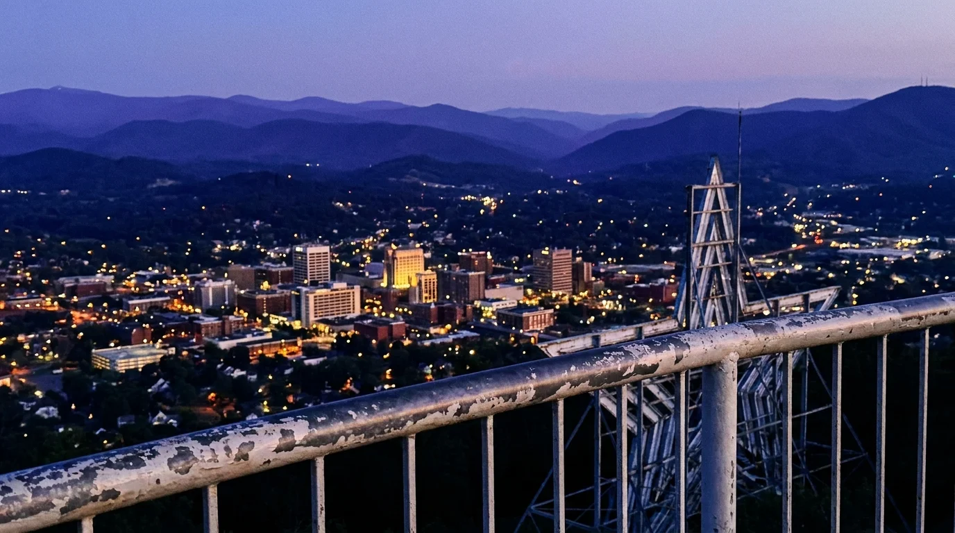 The city of Roanoke, Virginia, nestled in a valley surrounded by the Blue Ridge Mountains at dusk.