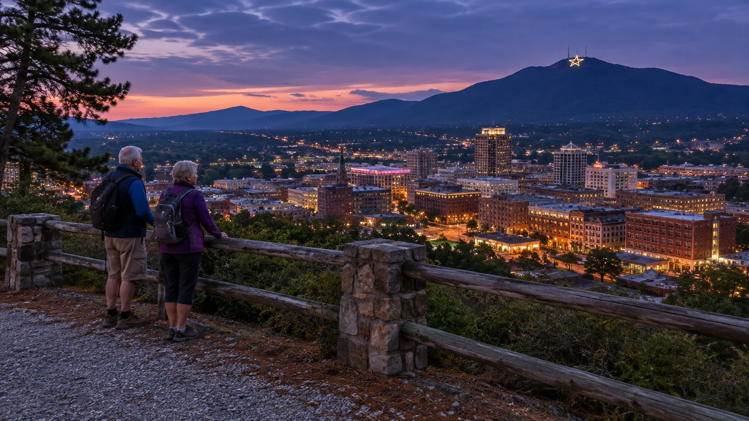 Two hikers overlook an illuminated city at dusk with an illuminated star visible on a distant mountain peak.